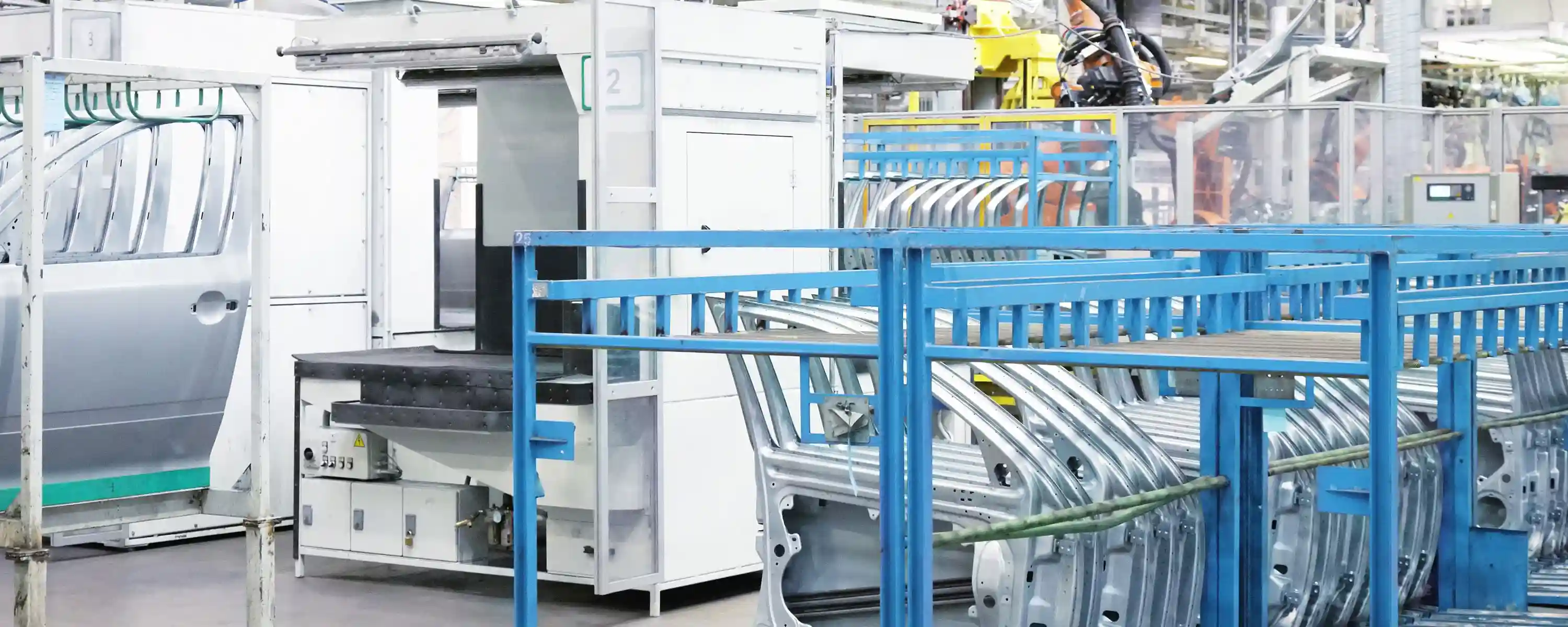Automated production line in automotive manufacturing with body parts on a roller conveyor – OEE software tracks the availability, performance, and quality of these systems in real time